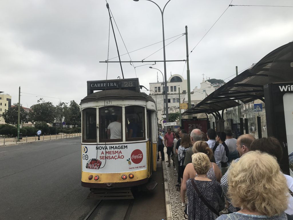 Warten auf Tram 28 an der Haltestelle Martim Moniz